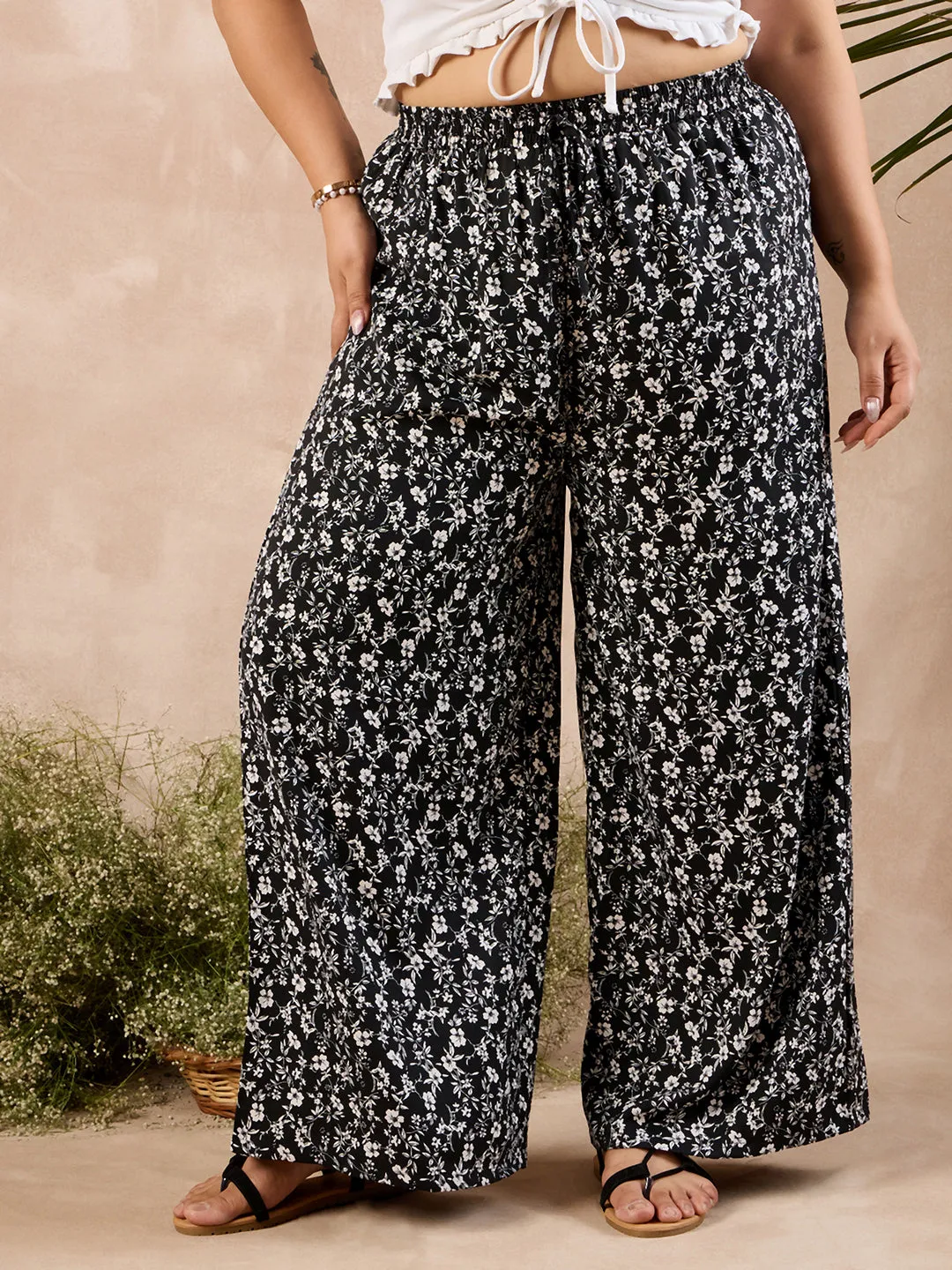 Berrylush Curve Women Black & White Floral Printed High-Rise Elastic Waist Relaxed-Fit Tie-Up Wide-Leg Trousers